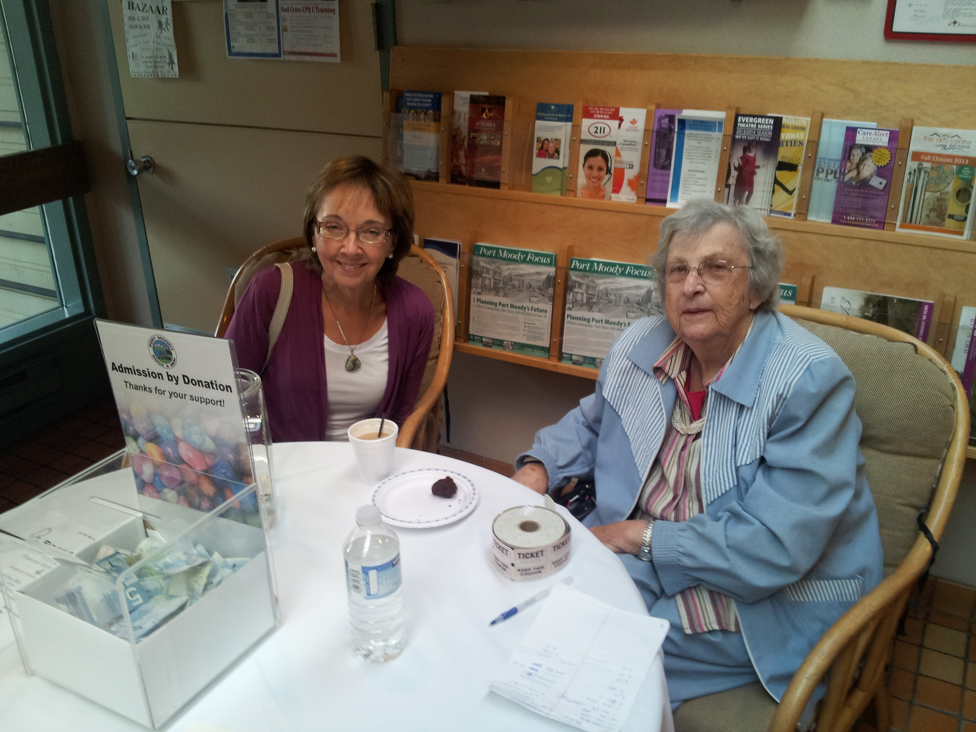 Two longtime club volunteers seated at the admission table during the 2013 From Then to Now show.